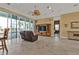 Spacious living room with tile flooring, tan walls, a ceiling fan, and a sliding glass door at 960 Messina Dr, Punta Gorda, FL 33950