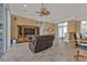 Spacious living room with tile floors, tan walls, ceiling fan, and sliding doors to the patio at 960 Messina Dr, Punta Gorda, FL 33950