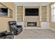 Relax in this cozy living room, featuring stone accents and built-in shelving at 960 Messina Dr, Punta Gorda, FL 33950
