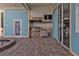 Outdoor kitchen with brickwork, stainless steel appliances, built-in grill and covered grilling area at 960 Messina Dr, Punta Gorda, FL 33950