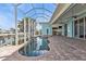 Beautiful screened-in pool and spa with view of outdoor kitchen at 960 Messina Dr, Punta Gorda, FL 33950
