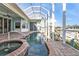 Beautiful screened-in pool and spa overlooking the waterfront canal at 960 Messina Dr, Punta Gorda, FL 33950