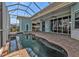 View of outdoor kitchen and beautiful screened-in pool and spa at 960 Messina Dr, Punta Gorda, FL 33950
