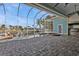 Screened-in pool area features a hot tub, with brick pavers, and a view of the canal and dock at 960 Messina Dr, Punta Gorda, FL 33950