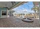Screened-in pool and hot tub area overlooking a canal with boat docks and beautiful brick pavers at 960 Messina Dr, Punta Gorda, FL 33950