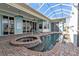 Pool area features a hot tub, with brick pavers, and covered grilling area at 960 Messina Dr, Punta Gorda, FL 33950