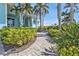 Landscaped brick path leading to a charming light blue home at 960 Messina Dr, Punta Gorda, FL 33950