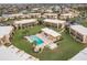 Aerial view showcasing residences, waterfront access, lush landscaping, and community pool at 1080 Bal Harbor Blvd # 4D, Punta Gorda, FL 33950