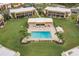 Aerial view of the community pool, surrounded by lush landscaping and well-maintained buildings at 1080 Bal Harbor Blvd # 4D, Punta Gorda, FL 33950