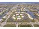 Aerial view of waterfront condos, pool, parking, manicured lawns, and canal access at 1080 Bal Harbor Blvd # 4D, Punta Gorda, FL 33950