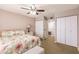 Comfortable bedroom with a floral bedspread, ceiling fan, and closet at 1080 Bal Harbor Blvd # 4D, Punta Gorda, FL 33950