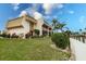 Attractive canal-front property with a manicured lawn, mature landscaping, and sunny skies at 1080 Bal Harbor Blvd # 4D, Punta Gorda, FL 33950