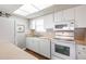 A well-lit kitchen featuring white appliances and plenty of counter and cabinet space at 1080 Bal Harbor Blvd # 4D, Punta Gorda, FL 33950