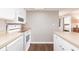 Kitchen features white appliances and plenty of counter space, adjacent to bedroom and bathroom at 1080 Bal Harbor Blvd # 4D, Punta Gorda, FL 33950