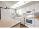Well-lit kitchen featuring white appliances and ample counter space at 1080 Bal Harbor Blvd # 4D, Punta Gorda, FL 33950