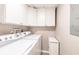 Functional laundry room with white washer and dryer units and ample cabinet space at 1080 Bal Harbor Blvd # 4D, Punta Gorda, FL 33950