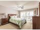 Bright main bedroom with a ceiling fan, a king bed, and sliding glass doors to a screened lanai at 1080 Bal Harbor Blvd # 4D, Punta Gorda, FL 33950