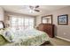Comfortable main bedroom with a ceiling fan, king bed, dresser, and sliding glass doors to a screened lanai at 1080 Bal Harbor Blvd # 4D, Punta Gorda, FL 33950