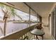 Screened-in patio overlooking a serene canal with swaying palm trees and tropical scenery at 1080 Bal Harbor Blvd # 4D, Punta Gorda, FL 33950