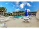 This community pool features lounge chairs, tables, and umbrellas at 1080 Bal Harbor Blvd # 4D, Punta Gorda, FL 33950