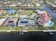 Aerial view of waterfront homes with private docks and enclosed pools along the canal, lush tropical landscaping at 1105 Rum Cay Ct, Punta Gorda, FL 33950