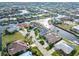 Waterfront homes line the canal in this aerial view, lush tropical landscaping at 1105 Rum Cay Ct, Punta Gorda, FL 33950