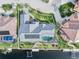 Aerial view highlighting the home's premium waterfront location, solar panels, private pool, and canal access at 1105 Rum Cay Ct, Punta Gorda, FL 33950