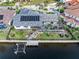 Aerial view of a beautiful home with a pool, solar panels, a canal, and a boat dock at 1105 Rum Cay Ct, Punta Gorda, FL 33950