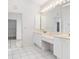 Bright bathroom with double sinks and a vanity area, connecting to walk in closet at 1105 Rum Cay Ct, Punta Gorda, FL 33950