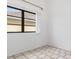 Bright bedroom with a large window, neutral walls, and tiled flooring offers a calming and inviting atmosphere at 1105 Rum Cay Ct, Punta Gorda, FL 33950