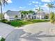 Charming single-story home with a well-manicured lawn and mature palm trees in a tropical setting at 1105 Rum Cay Ct, Punta Gorda, FL 33950