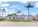 Charming one-story home featuring palm trees, a tile roof, an attached garage, and a well-kept lawn at 1105 Rum Cay Ct, Punta Gorda, FL 33950