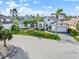 Attractive waterfront home featuring lush landscaping and circular driveway, showcasing curb appeal at 1105 Rum Cay Ct, Punta Gorda, FL 33950