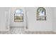 Bright, open foyer with tiled floors, arched windows and a modern chandelier at 1105 Rum Cay Ct, Punta Gorda, FL 33950