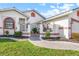 Charming front entrance features a black metal gate, lush landscaping, and a paved walkway at 1105 Rum Cay Ct, Punta Gorda, FL 33950