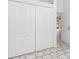 Hallway with large white closet, tile flooring, and a glimpse of a bright space, offering functionality and style at 1105 Rum Cay Ct, Punta Gorda, FL 33950