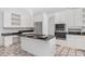 Bright kitchen featuring stainless steel appliances, white cabinets, and a kitchen island at 1105 Rum Cay Ct, Punta Gorda, FL 33950