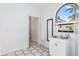 Bright laundry room featuring a sink and an arched window and access to the exterior of the house at 1105 Rum Cay Ct, Punta Gorda, FL 33950