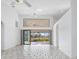 Bright, open-plan living space with high ceilings, tiled floors, and sliding glass doors to the patio at 1105 Rum Cay Ct, Punta Gorda, FL 33950