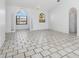 Bright living room featuring arched windows, tile flooring, and a ceiling fan at 1105 Rum Cay Ct, Punta Gorda, FL 33950