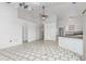Open concept living room flows to kitchen area with tiled floor and high ceiling at 1105 Rum Cay Ct, Punta Gorda, FL 33950
