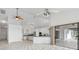 Bright open layout, living room flowing into kitchen with tiled floors, high ceilings and a screened patio at 1105 Rum Cay Ct, Punta Gorda, FL 33950