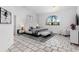 Bright main bedroom with elegant furnishings, tiled floors, arched window, and walk-in closet at 1105 Rum Cay Ct, Punta Gorda, FL 33950