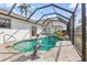 Enclosed swimming pool has a statue and a stone patio at 1105 Rum Cay Ct, Punta Gorda, FL 33950