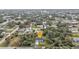 Aerial view of home in a quiet neighborhood surrounded by mature trees at 1117 Vernon Ave, Port Charlotte, FL 33948