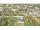 Aerial shot of a charming home nestled among lush greenery, near quiet streets and neighboring houses at 1117 Vernon Ave, Port Charlotte, FL 33948