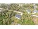 Aerial view of a home surrounded by trees, showcasing its lot and proximity to nearby houses at 1117 Vernon Ave, Port Charlotte, FL 33948