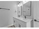 Contemporary bathroom featuring a double sink vanity, framed mirrors, and modern black hardware at 1117 Vernon Ave, Port Charlotte, FL 33948