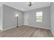 Spacious bedroom with a large window, neutral walls, and wood-look vinyl floors at 1117 Vernon Ave, Port Charlotte, FL 33948