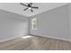 Bedroom with a ceiling fan and large window showing the tree outside the house at 1117 Vernon Ave, Port Charlotte, FL 33948